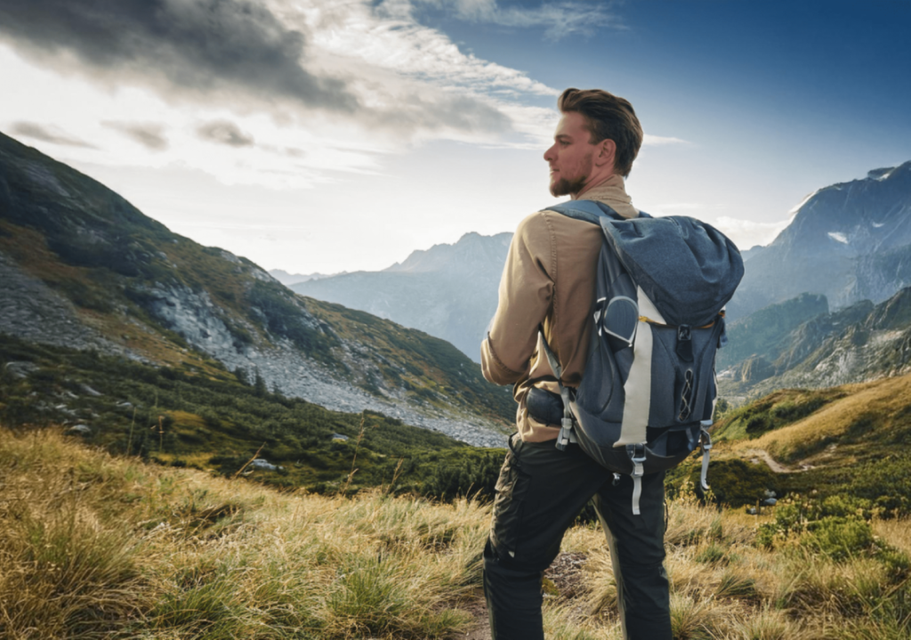 a-man-with-a-backpacking-backpack-hiking-in-a-mountain-area